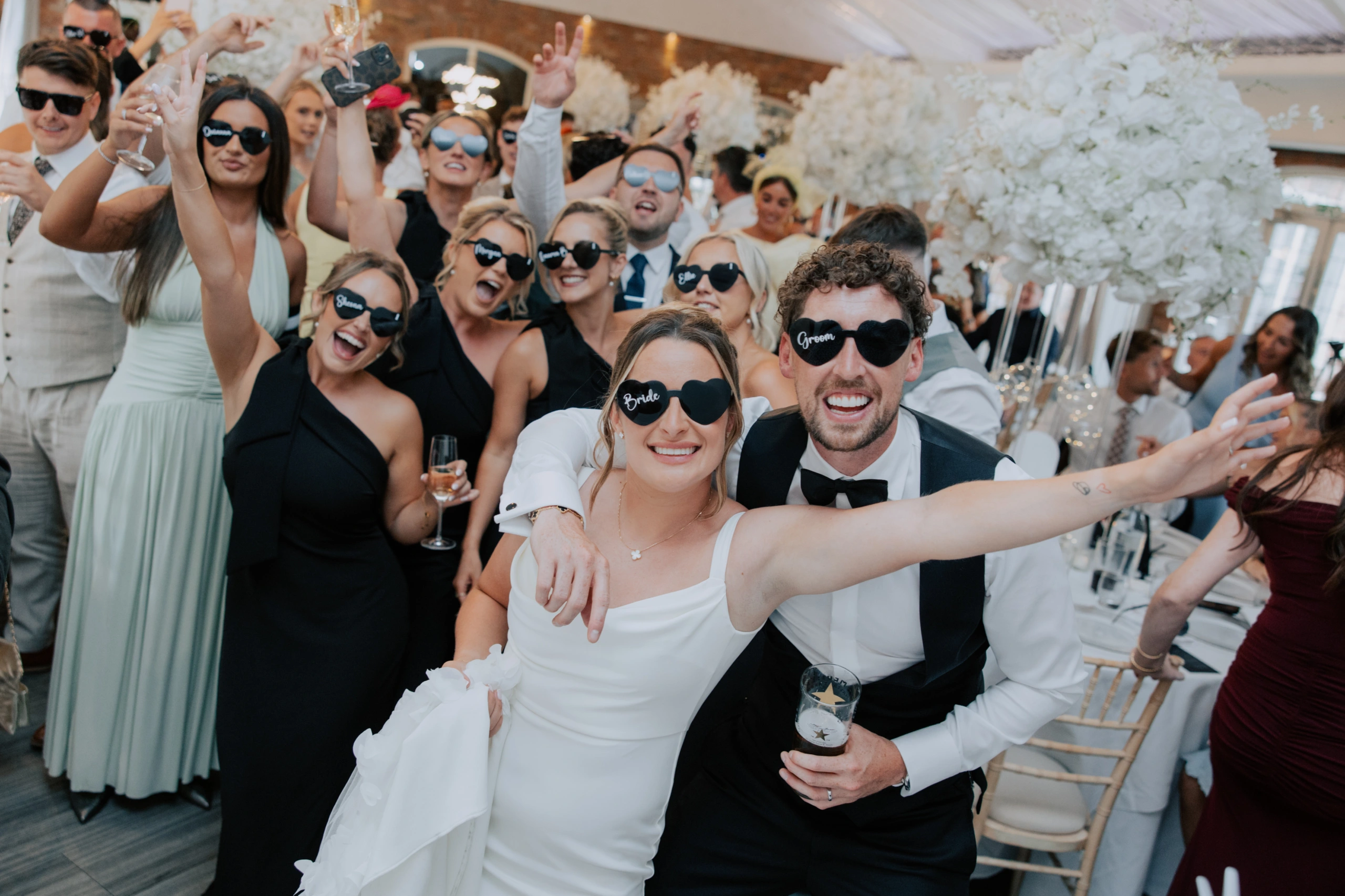 Joe and Ella celebrating with guests at their wedding breakfast